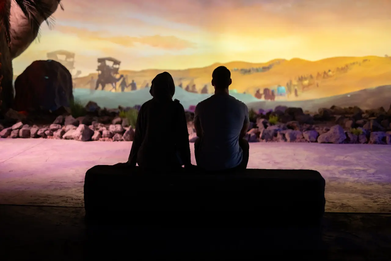 Two visitors enjoying an immersive art installation at the AlSirah Experience in Madinah